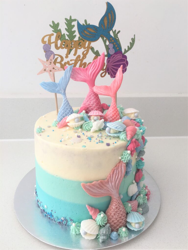 Decorated with pastel fondant tails and seashells