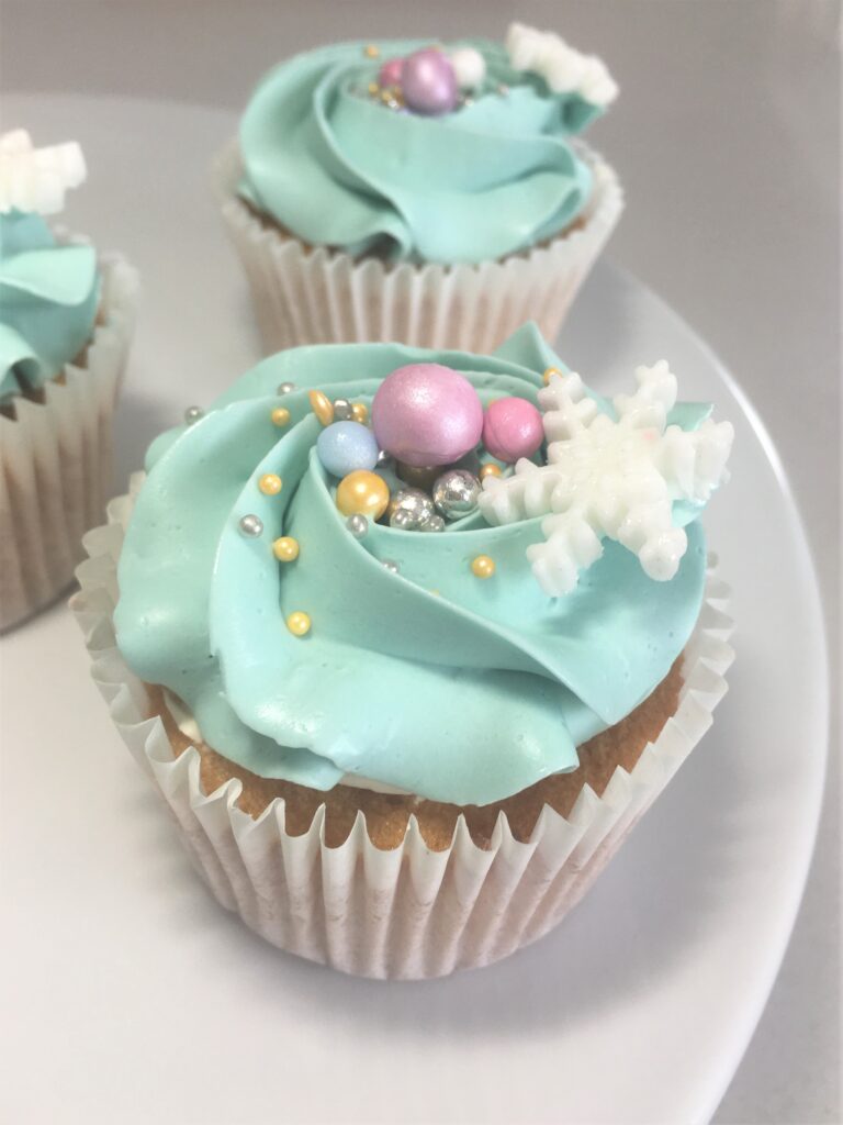 Festive cupcake with snowflake and bauble sprinkles