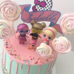 LOL Doll white chocolate drip cake with colourful sprinkles and meringue lollipops