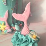 Mermaid cupcakes with edible tail, oyster shell and pearl and waves of swiss meringue buttercream