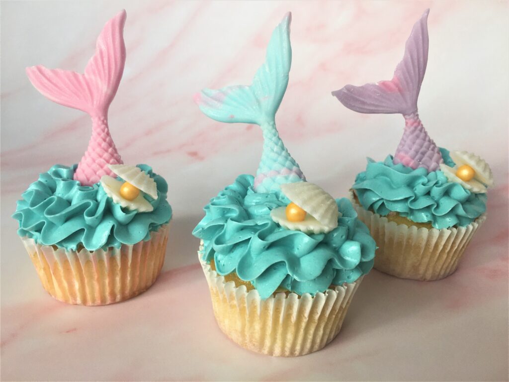 Mermaid cupcakes with edible tail, oyster shell and pearl and waves of swiss meringue buttercream