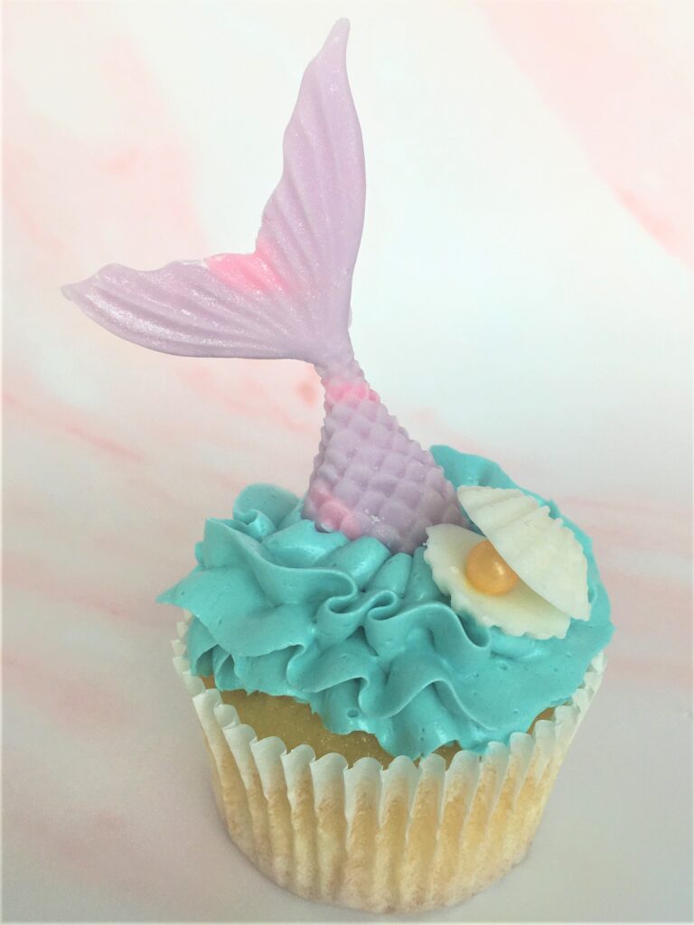 Mermaid cupcakes with edible tail, oyster shell and pearl and waves of swiss meringue buttercream