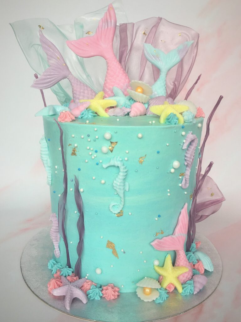 Decorated with pastel fondant tails and seashells with rice paper coral and gold leaf