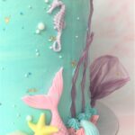 Decorated with pastel fondant tails and seashells with rice paper coral and gold leaf