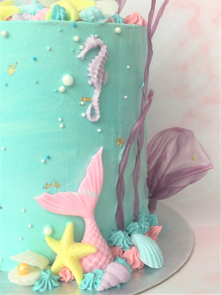 Decorated with pastel fondant tails and seashells with rice paper coral and gold leaf