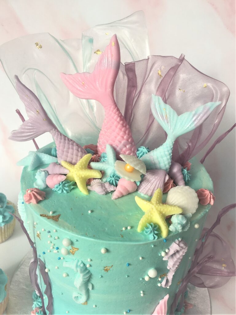 Decorated with pastel fondant tails and seashells with rice paper coral and gold leaf