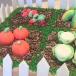 Garden Cake decorated with handmade fondant vegetables/fruit, chocolate mud and grass