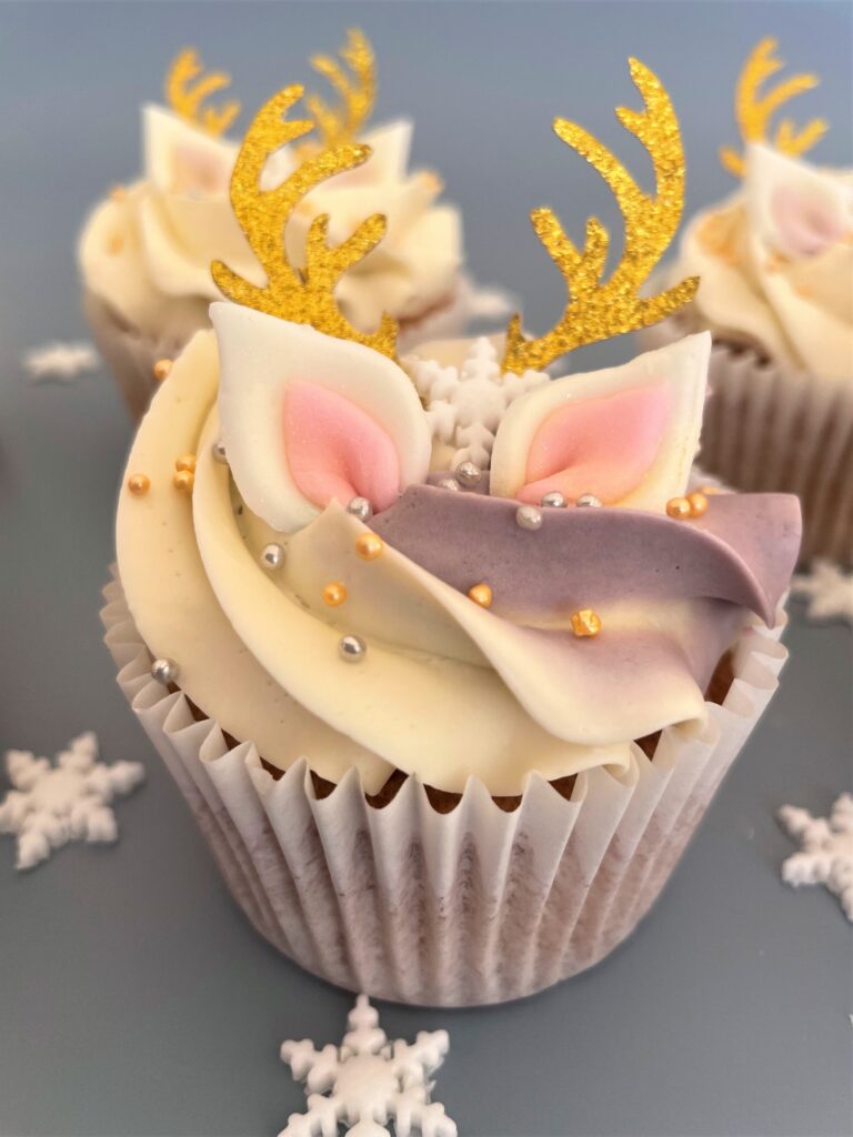 Reindeer Cupcake covered in smooth swiss meringue buttercream decorated with edible ears and snowflake