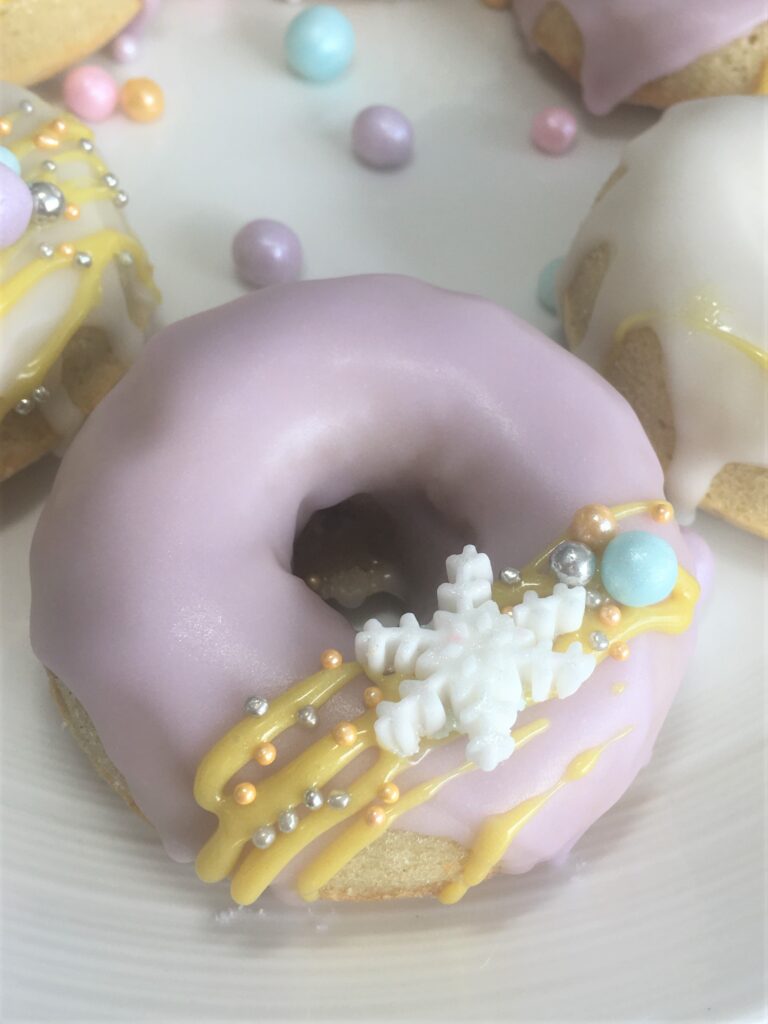 Festive iced doughnut with snowflake and bauble sprinkles