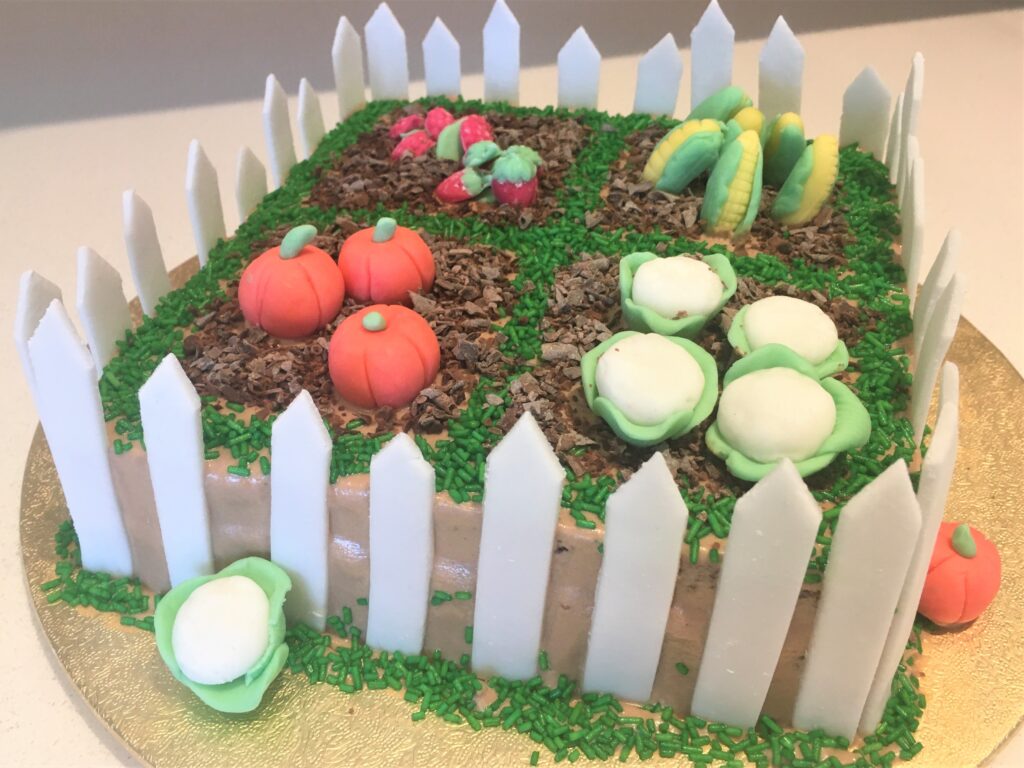 Garden Cake decorated with handmade fondant vegetables/fruit, chocolate mud and grass