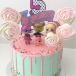 LOL Doll white chocolate drip cake with colourful sprinkles and meringue lollipops