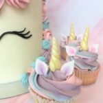 Unicorn cupcake with edible ears and horn and a swirl of magical swiss meringue buttercream