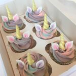 Unicorn cupcake with edible ears and horn and a swirl of magical swiss meringue buttercream