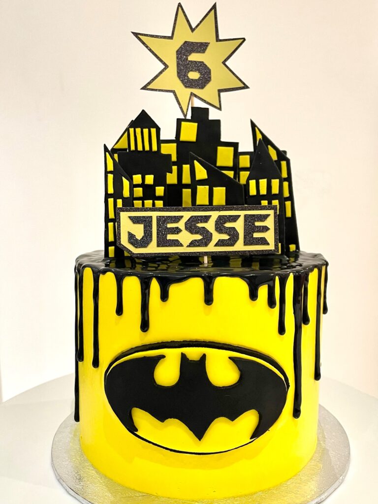 Batman drip cake with handmade batman sign and buildings