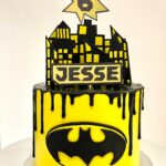 Superhero / Batman drip cake with handmade batman sign and decorations