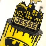 Superhero / Batman drip cake with handmade batman sign and decorations