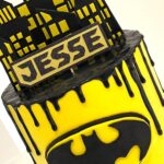 Superhero / Batman drip cake with handmade batman sign and decorations